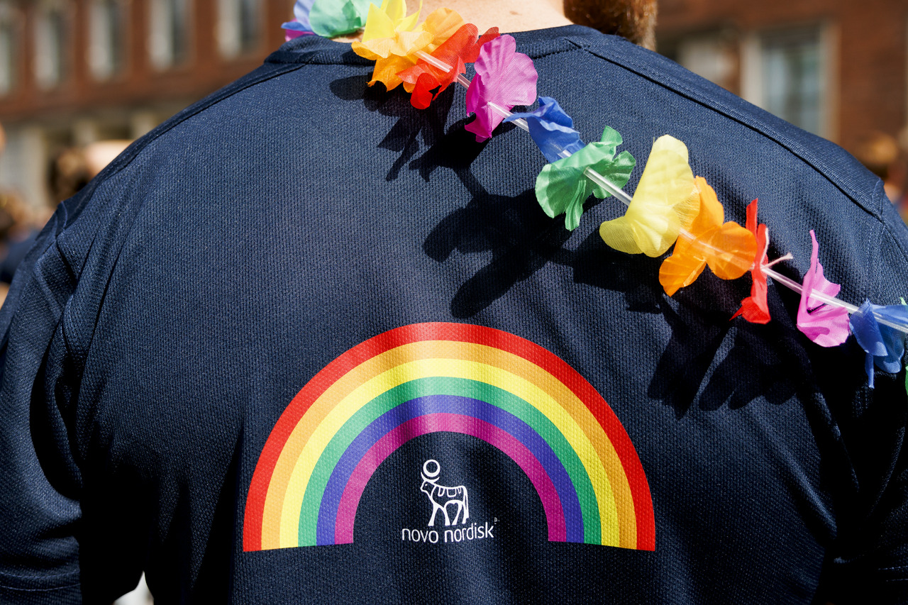 Our colleague has an LGBTQ+ rainbow above the Novo Nordisk logo on the back of his dark blue sweater